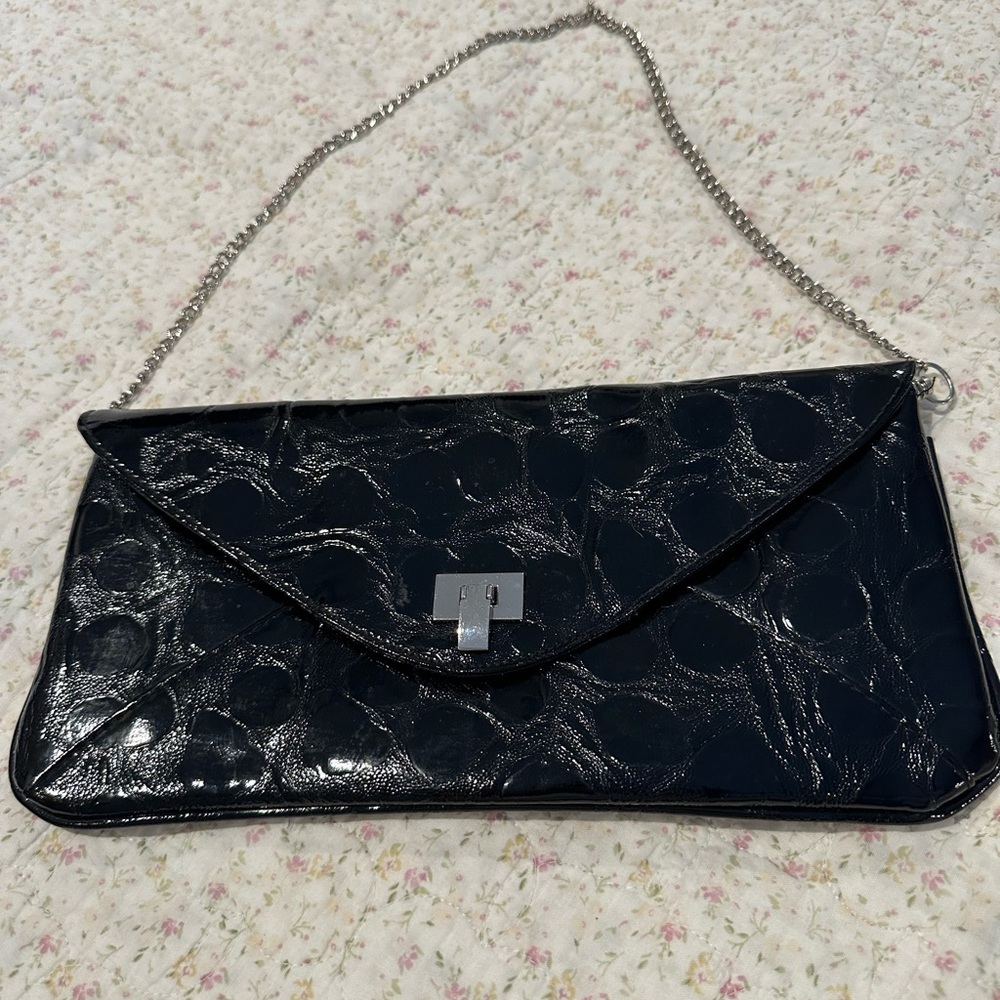 Black faux reptile clutch purse. Chain strap metal closure. Zipper pocket inside